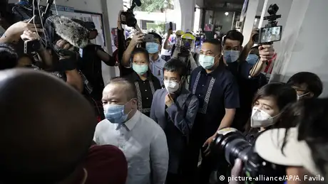 Rappler CEO and Executive Editor Maria Ressa, center, is escorted as she arrives to attend a court hearing for a cyber libel case at Manila Regional Trial Court, Philippines